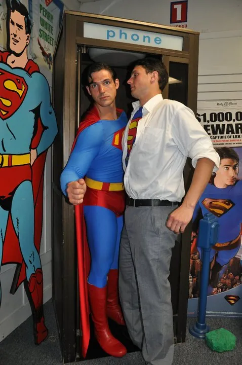 A roadside display showing Clark Kent stepping into a phone booth and emerging as Superman